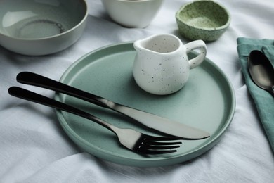 Photo of Stylish empty dishware and cutlery on table, closeup