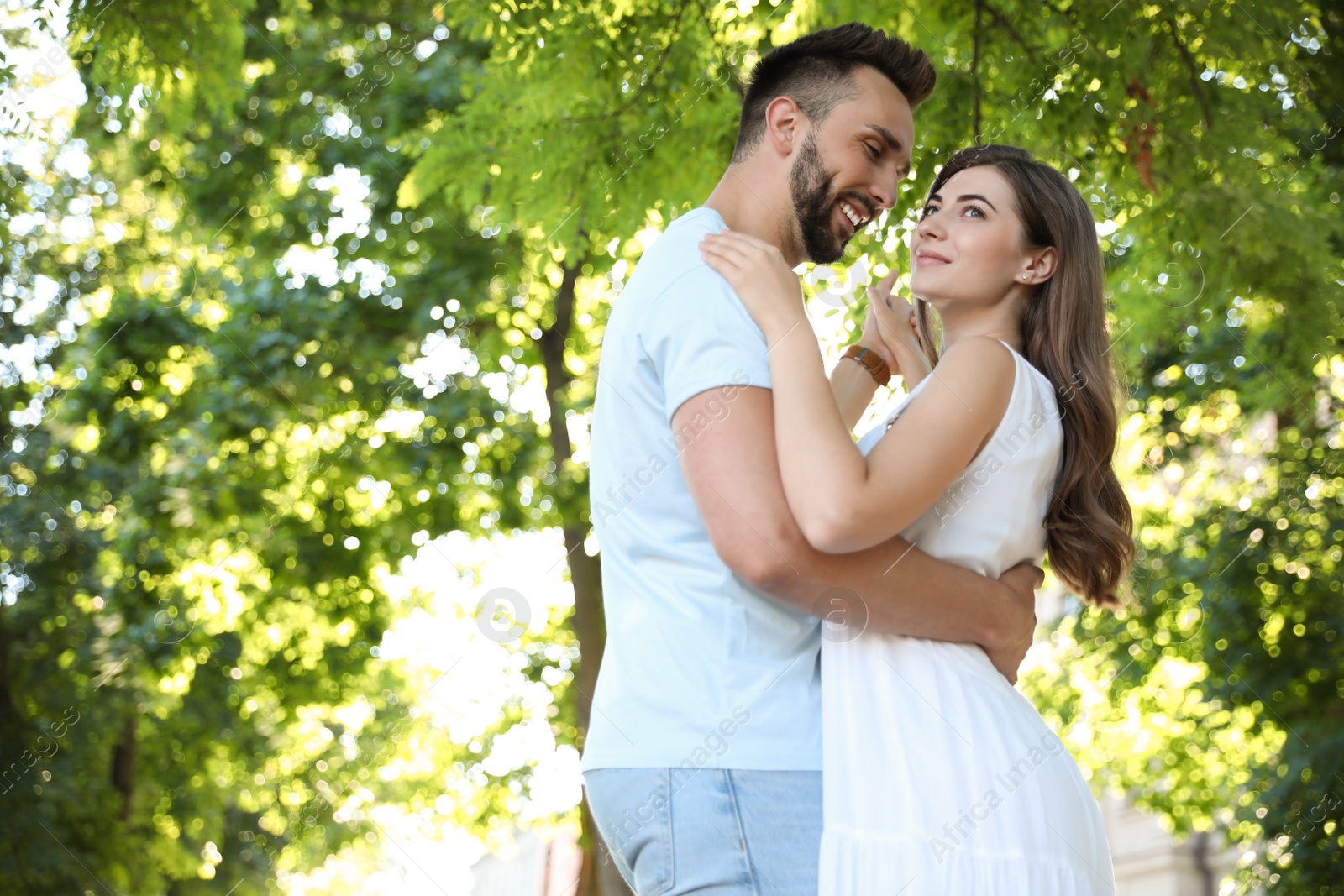 Photo of Lovely young couple dancing together in park on sunny day