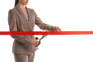 Woman in office suit cutting red ribbon isolated on white, closeup