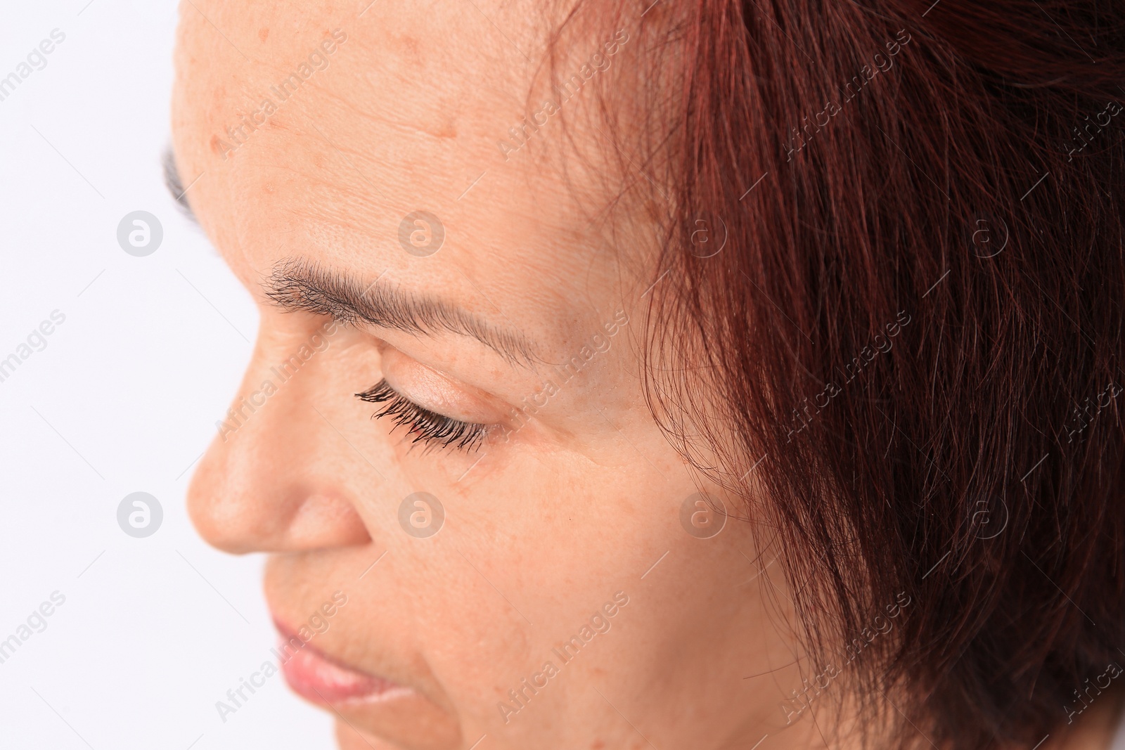 Photo of Closeup view of older woman on white background