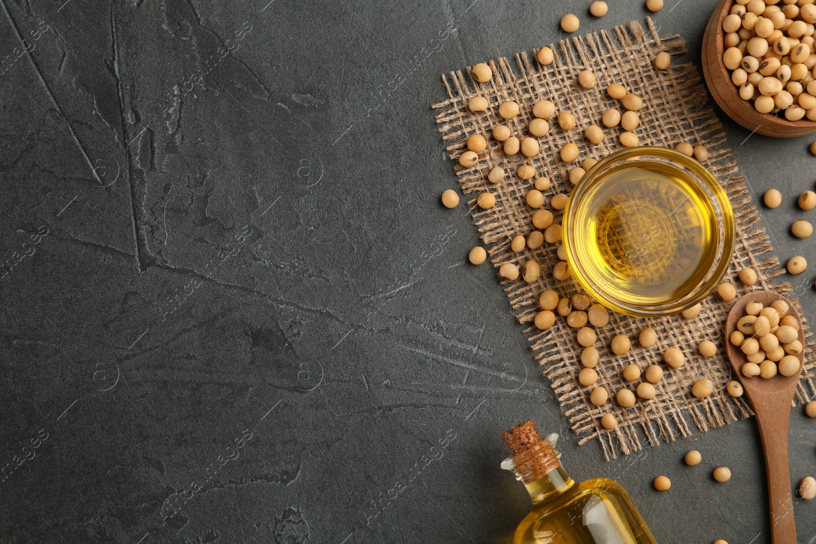 Photo of Flat lay composition with soybean oil on grey table. Space for text