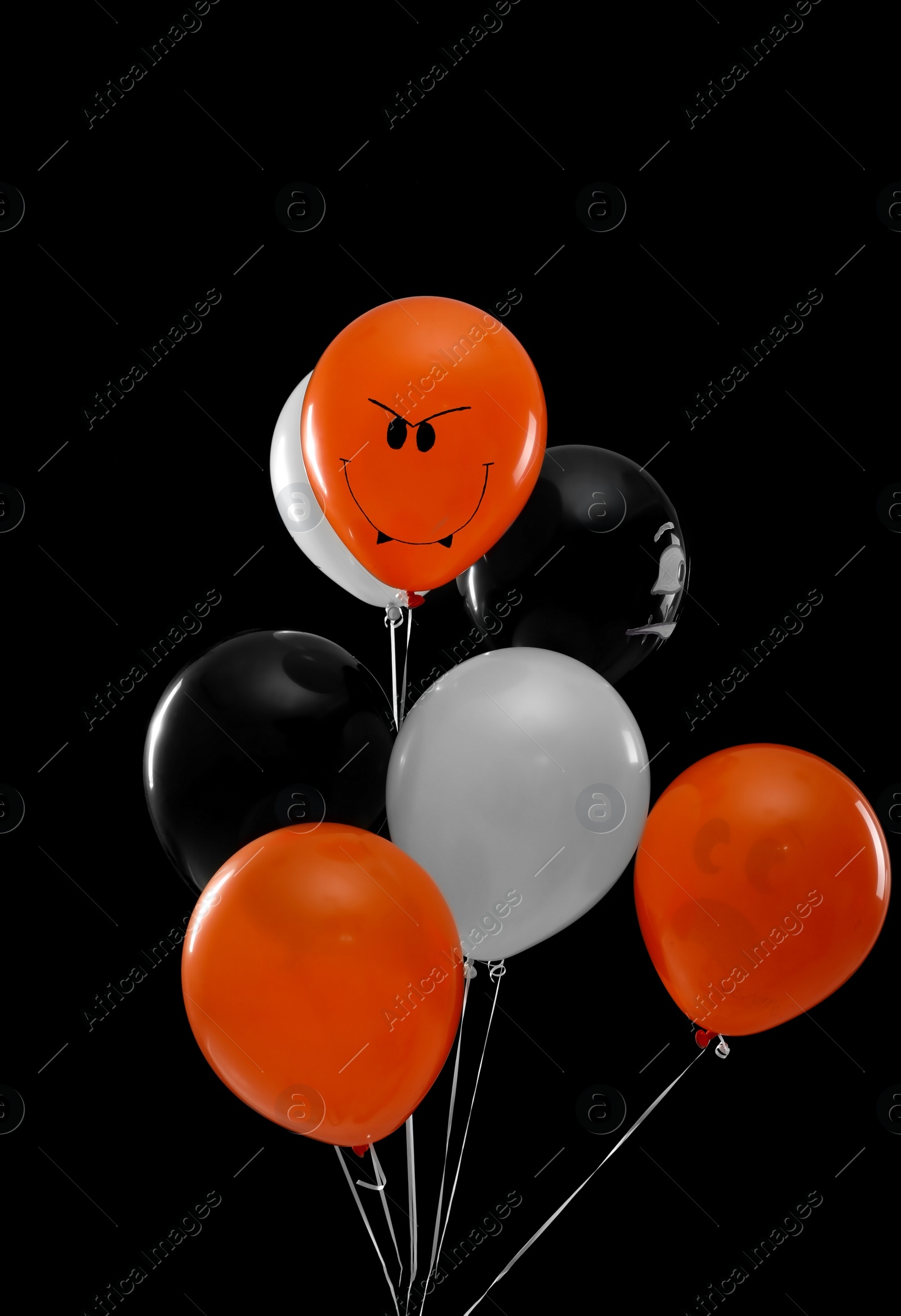 Photo of Color balloons for Halloween party on black background