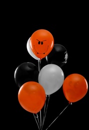 Photo of Color balloons for Halloween party on black background