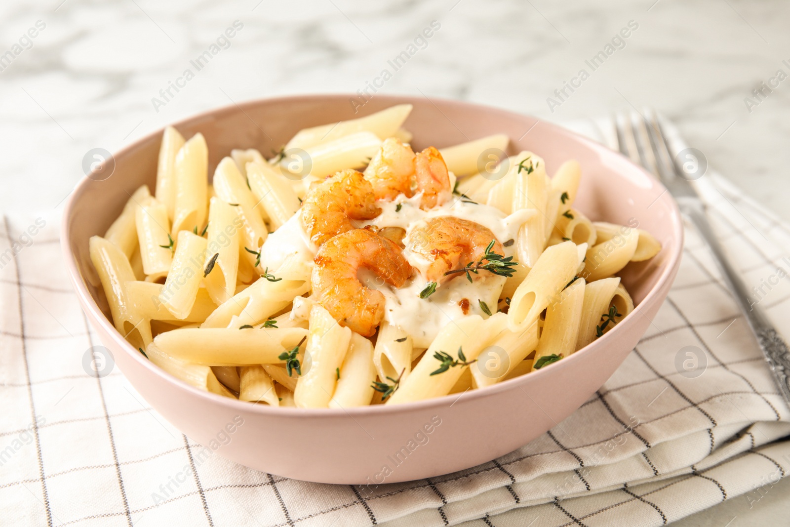 Photo of Delicious pasta with shrimps on white marble table