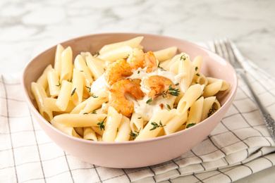 Delicious pasta with shrimps on white marble table