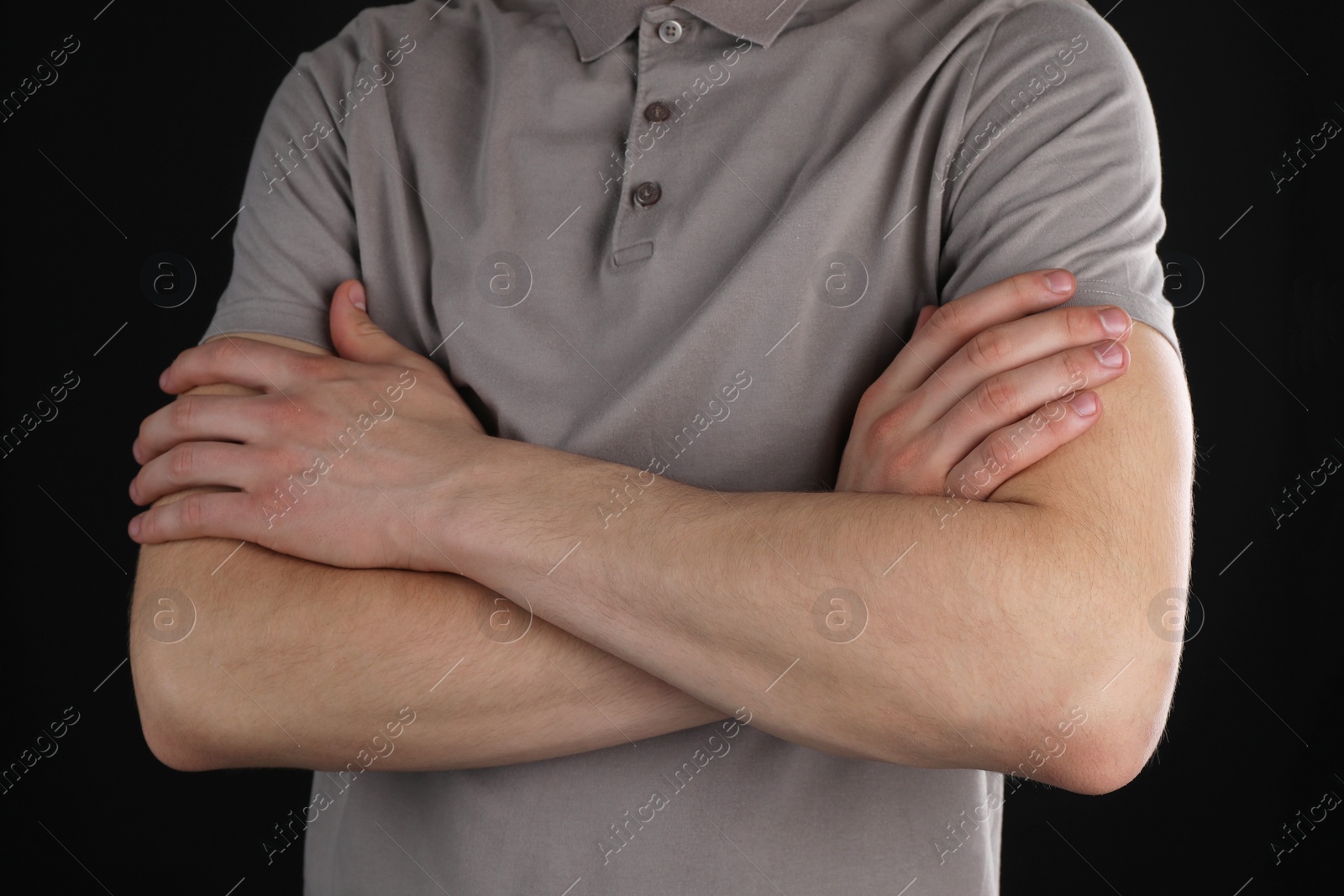 Photo of Man with space for tattoo on his arms against black background, closeup