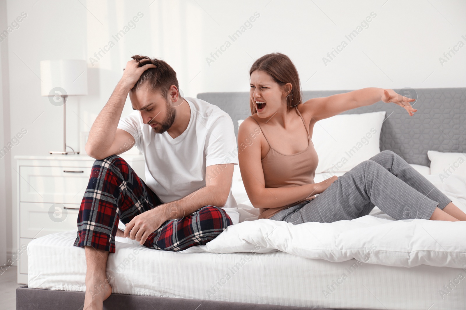 Photo of Unhappy young couple quarreling at home. Relationship problems