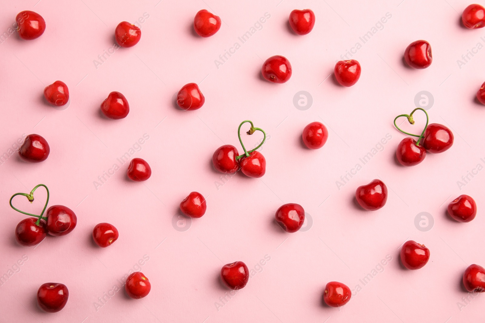 Photo of Flat lay composition with sweet red cherries on color background