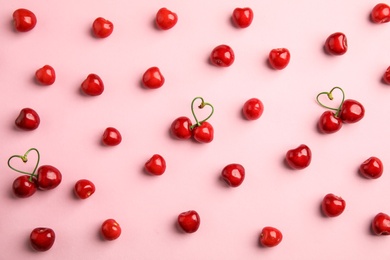 Flat lay composition with sweet red cherries on color background