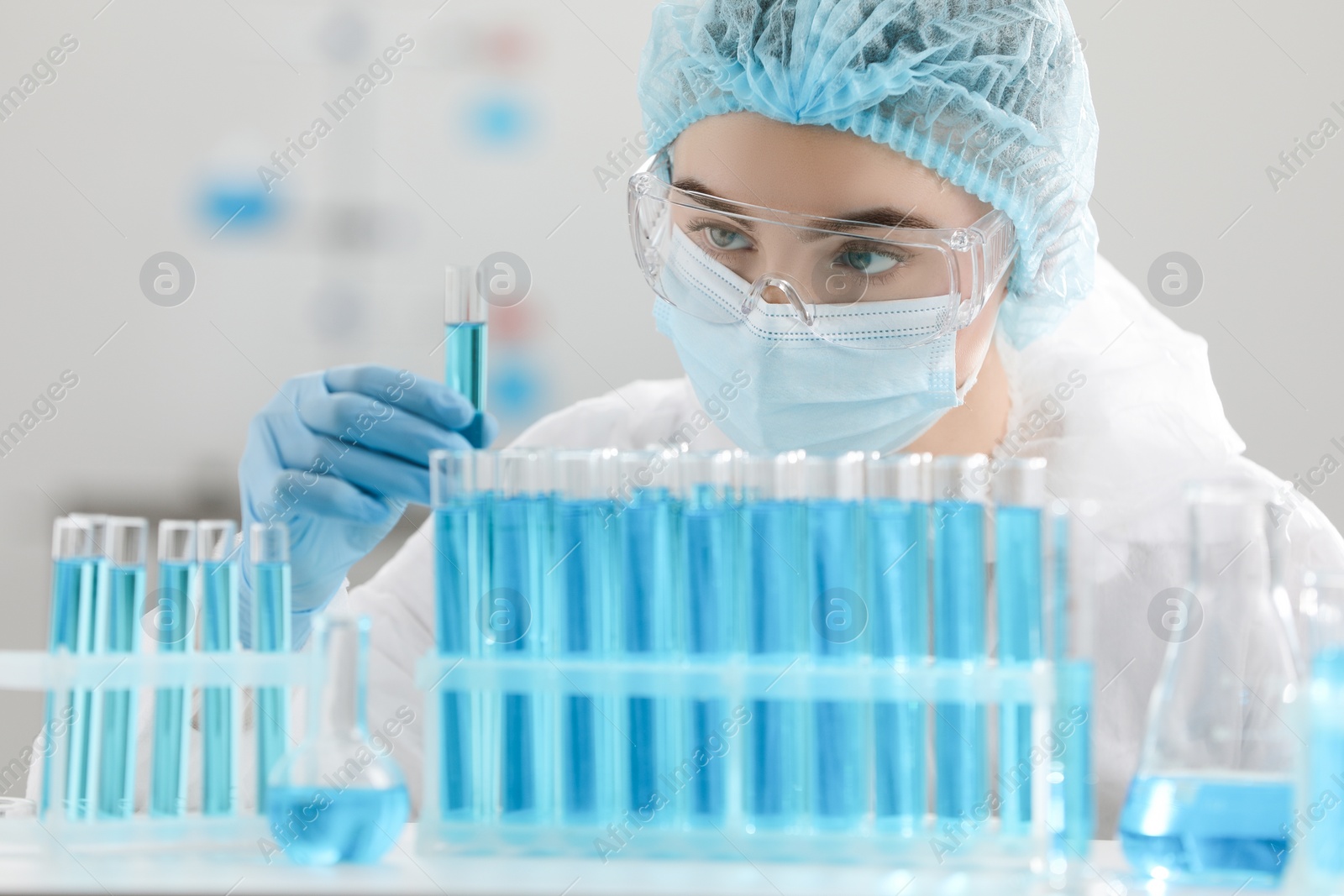 Photo of Scientist holding test tube with sample in laboratory