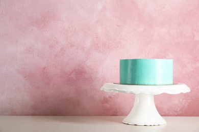 Fresh delicious birthday cake on stand against color background. Space for text