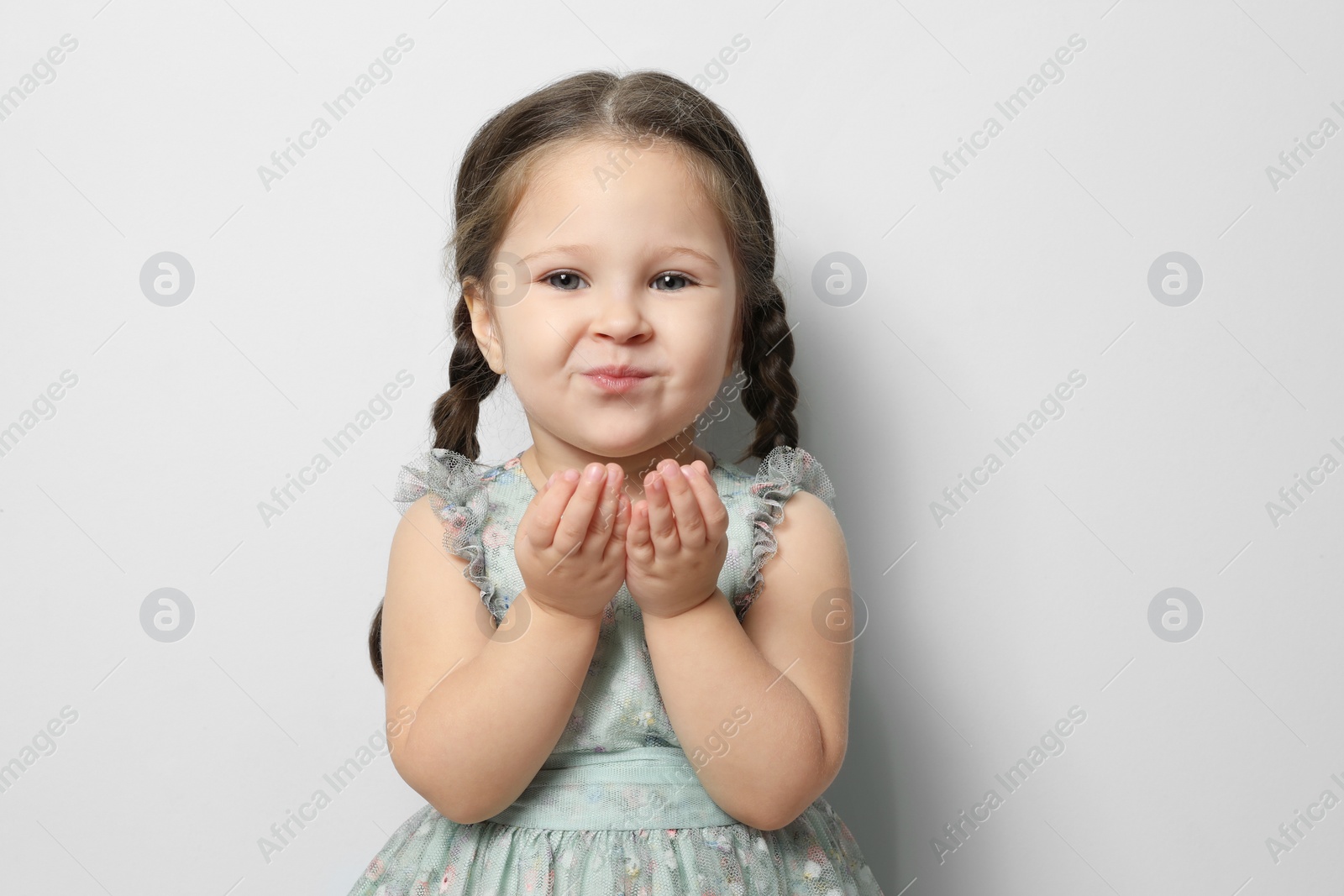 Photo of Cute little girl on light grey background