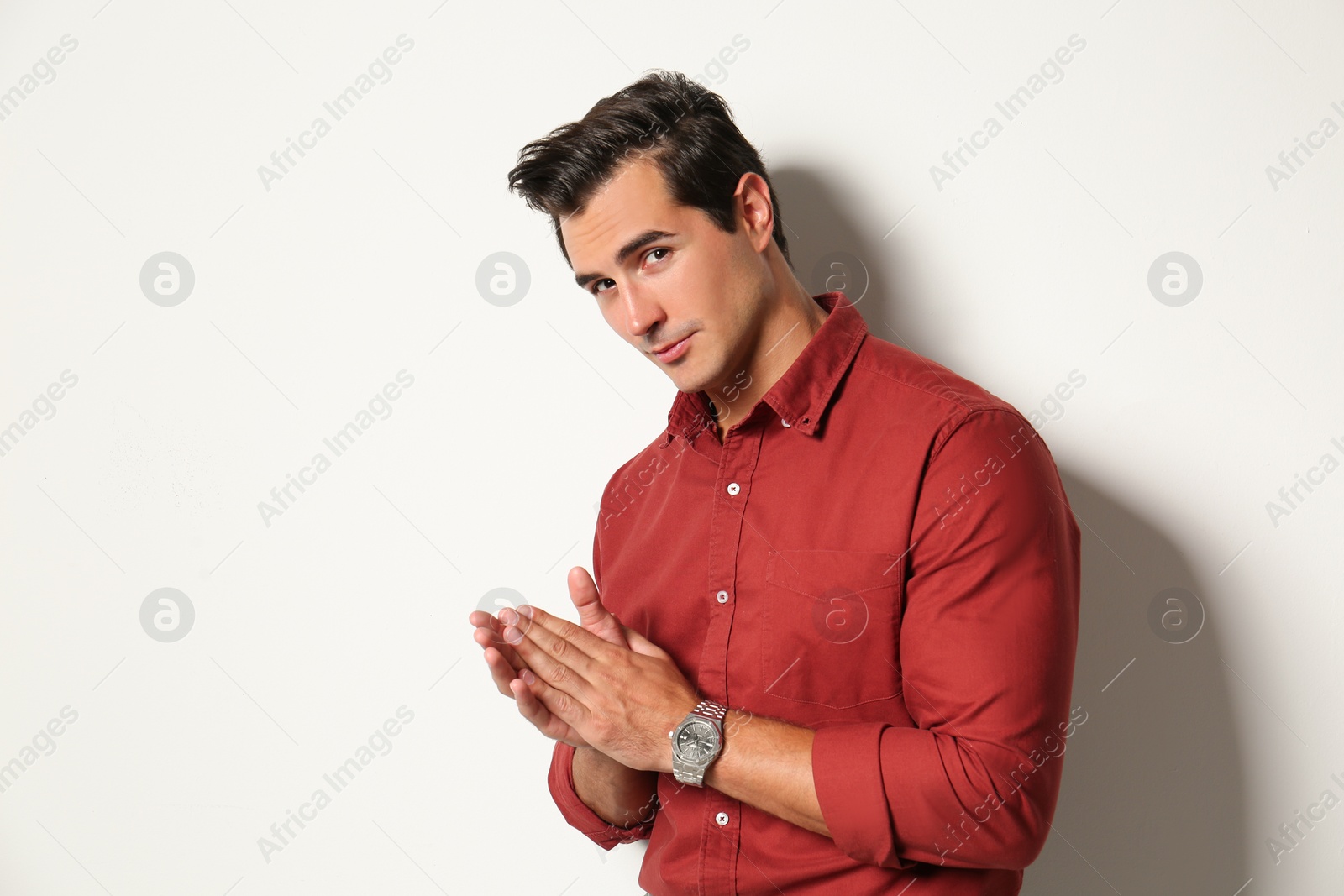 Photo of Handsome young man in stylish clothes on light beige background