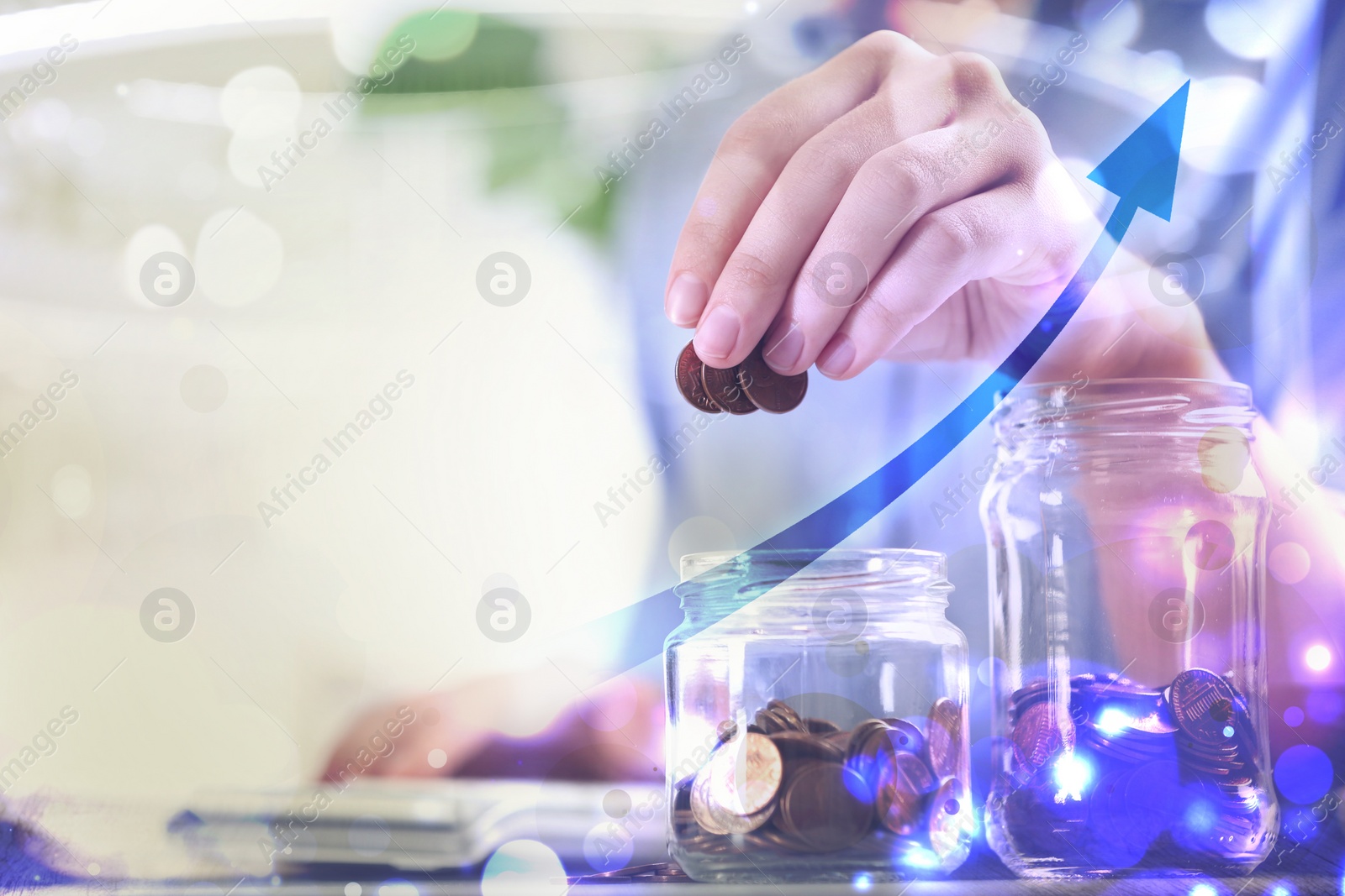Image of Woman putting money into glass jar at table, closeup