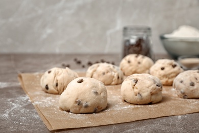 Photo of Fresh raw dough balls with chocolate chips on table
