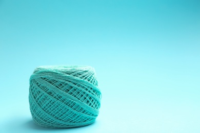 Photo of Clew of knitting threads on color background, space for text. Sewing stuff