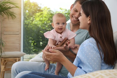 Photo of Happy family with their cute baby in living room at home