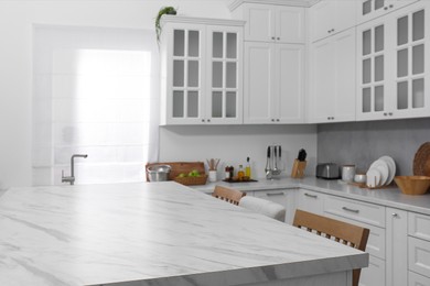 Stylish white marble table in kitchen. Interior design