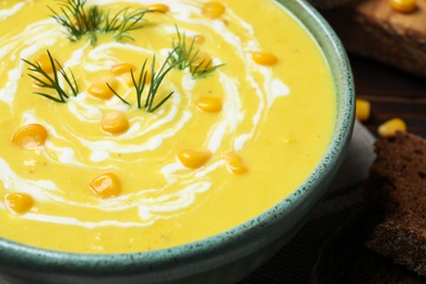 Delicious creamy corn soup in bowl, closeup