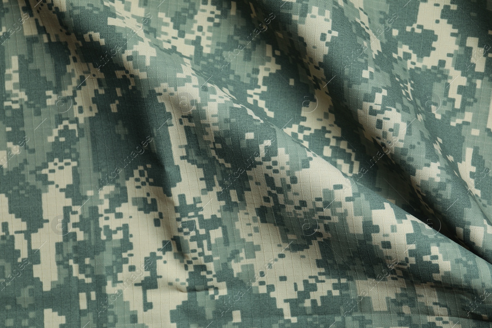 Photo of Texture of crumpled camouflage fabric as background, top view