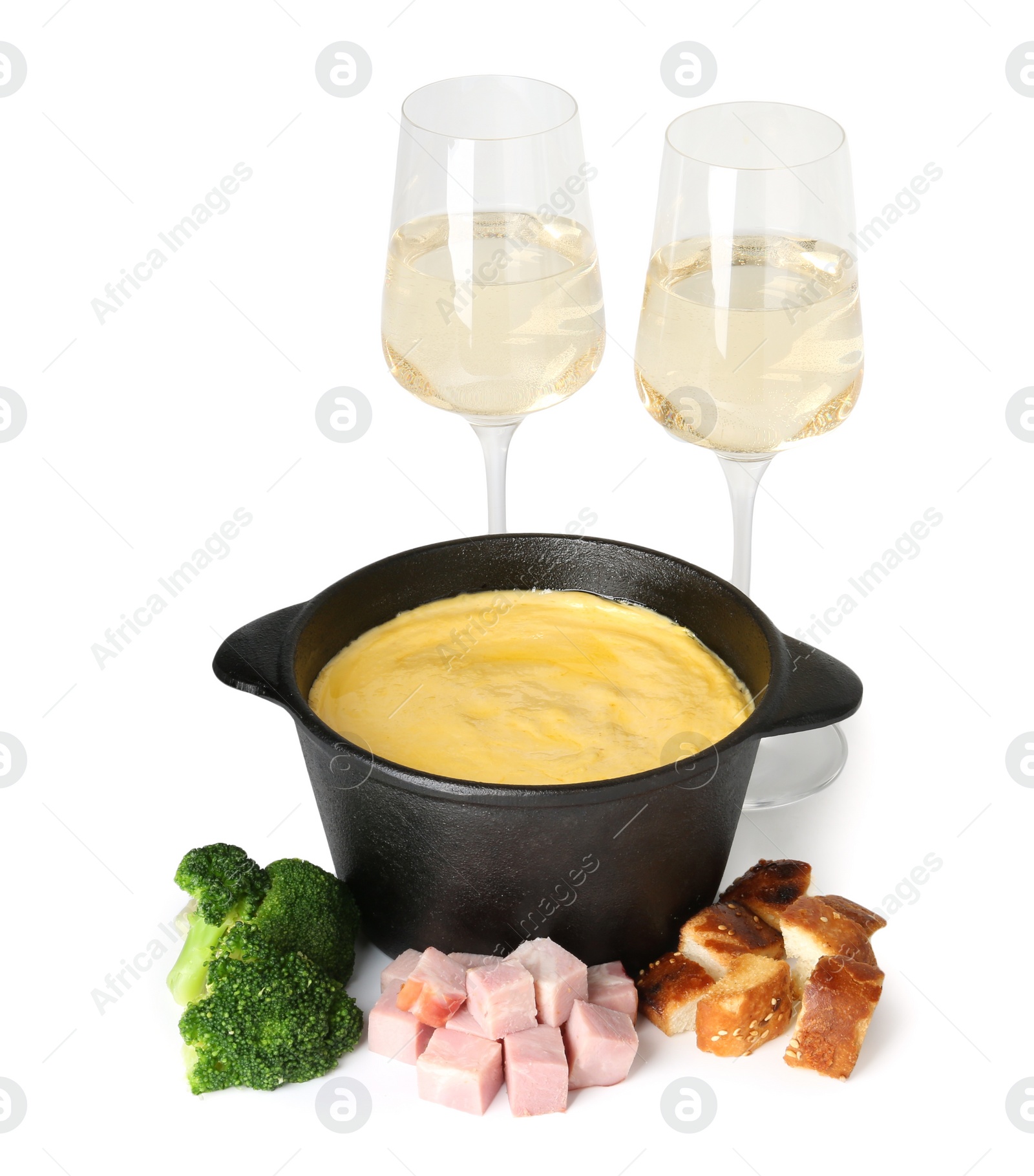 Photo of Fondue with tasty melted cheese, glasses of wine and different products isolated on white