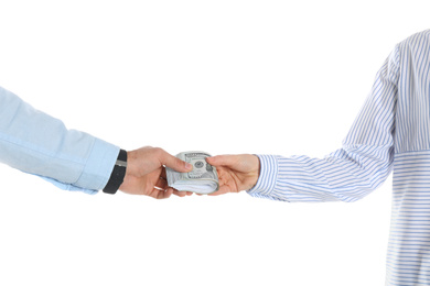 Man giving bribe money to woman on white background, closeup of hands
