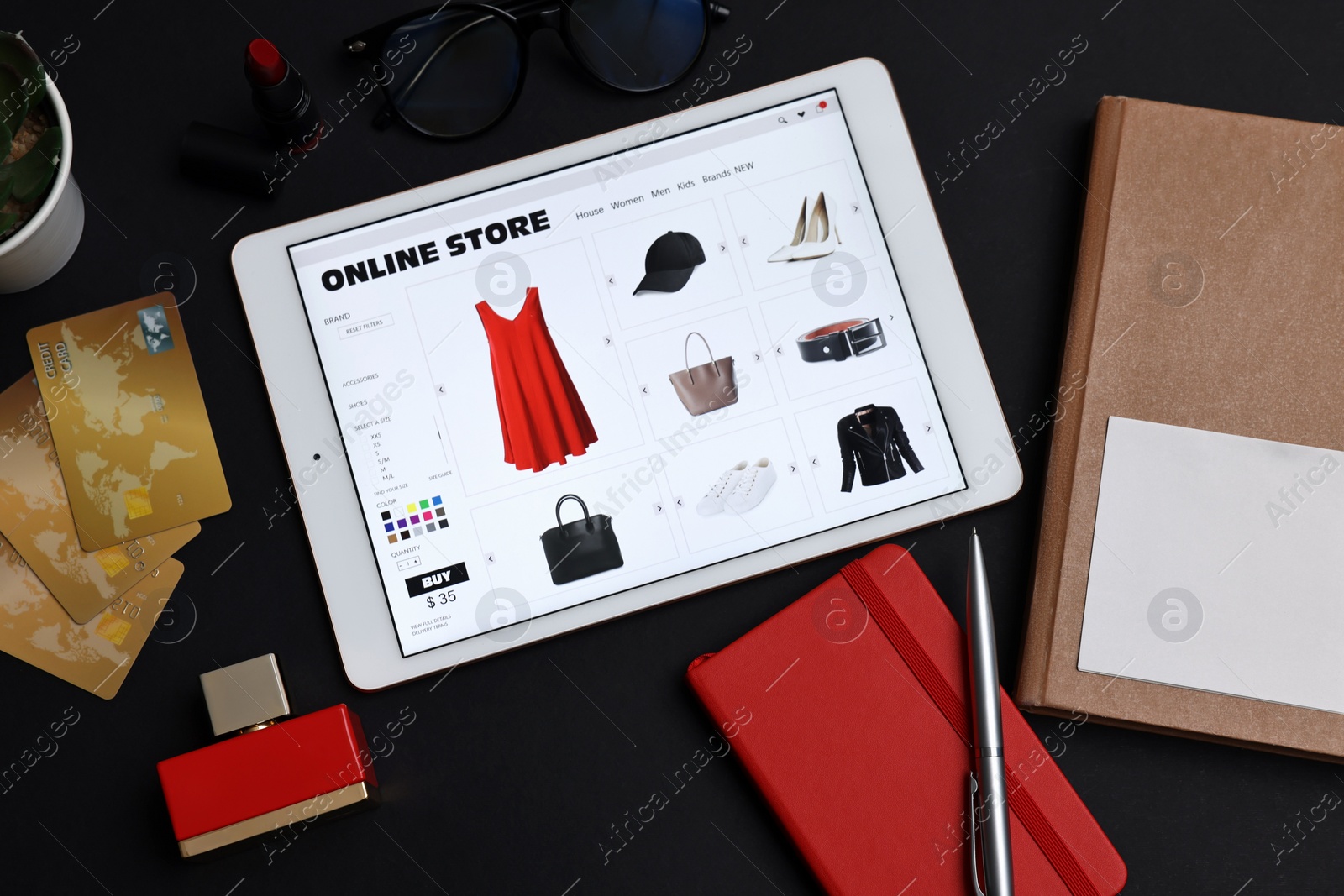 Photo of Online shopping. Flat lay composition with modern tablet on black background