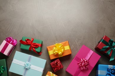 Photo of Many colorful gift boxes on grey table, flat lay. Space for text