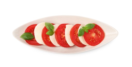 Photo of Plate of delicious Caprese salad with tomatoes, mozzarella and basil isolated on white, top view