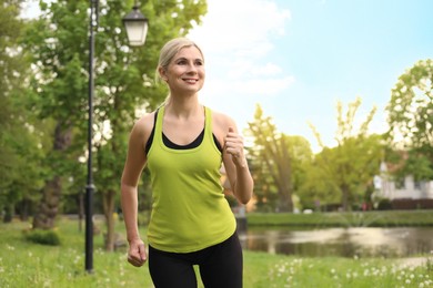 Photo of Beautiful woman jogging around park in morning
