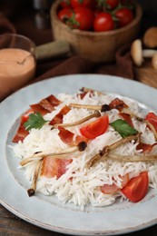 Photo of Delicious rice with bacon, mushrooms and tomatoes on table, closeup