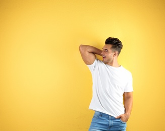 Photo of Young man in t-shirt on color background. Mockup for design