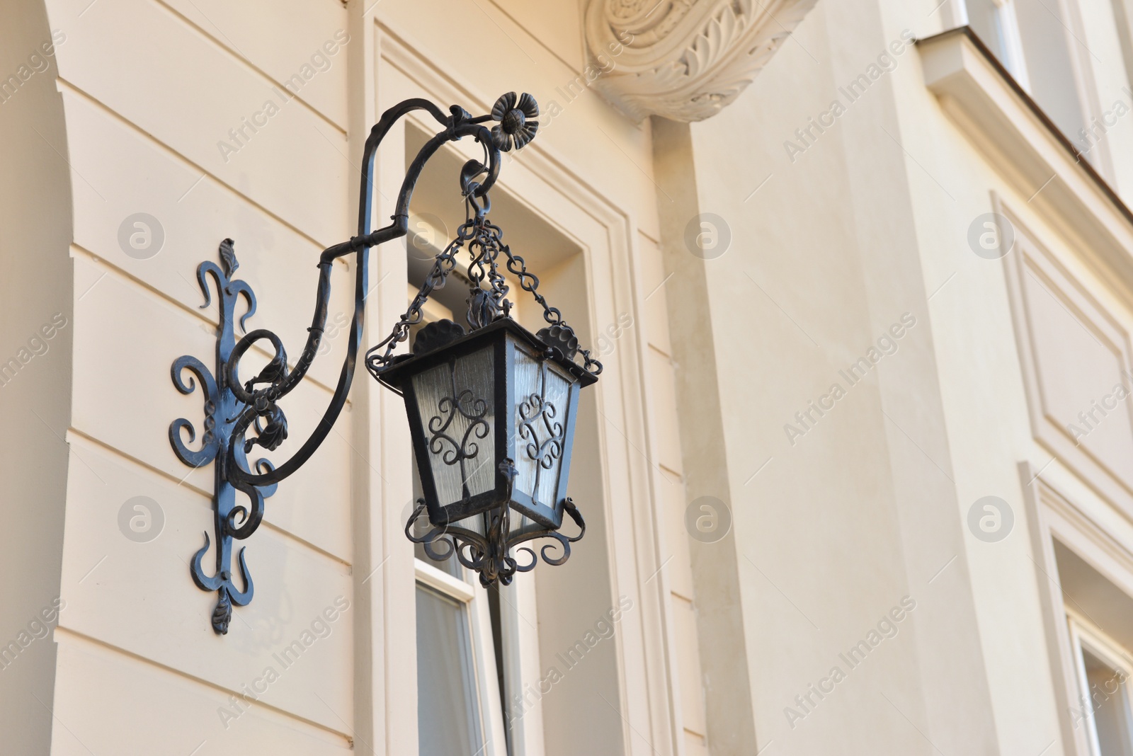 Photo of Beautiful vintage street lamp hanging on wall of building