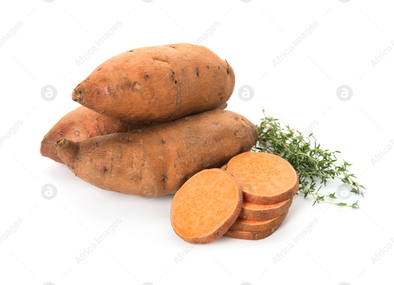 Photo of Cut and whole sweet potatoes with thyme on white background