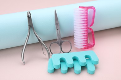 Set of pedicure tools on beige background