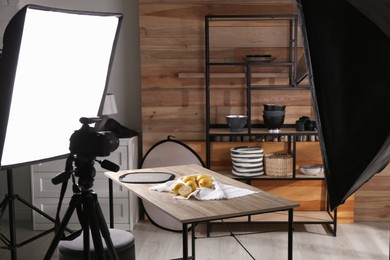 Professional equipment and many lemons on table in studio. Food photo