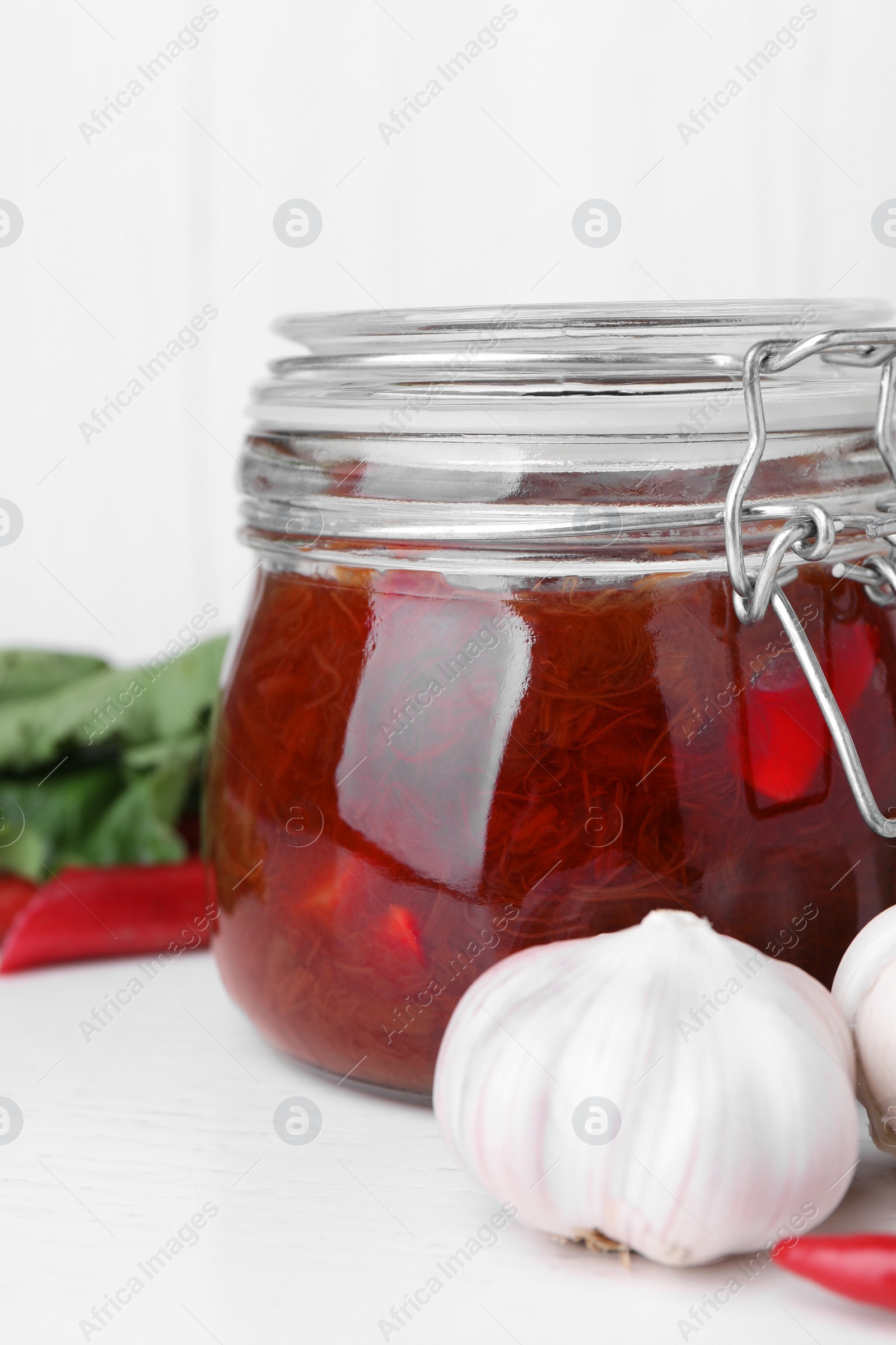 Photo of Tasty rhubarb sauce and ingredients on white table