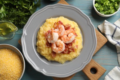 Photo of Plate with fresh tasty shrimps, bacon, grits and green onion on light blue wooden table, flat lay