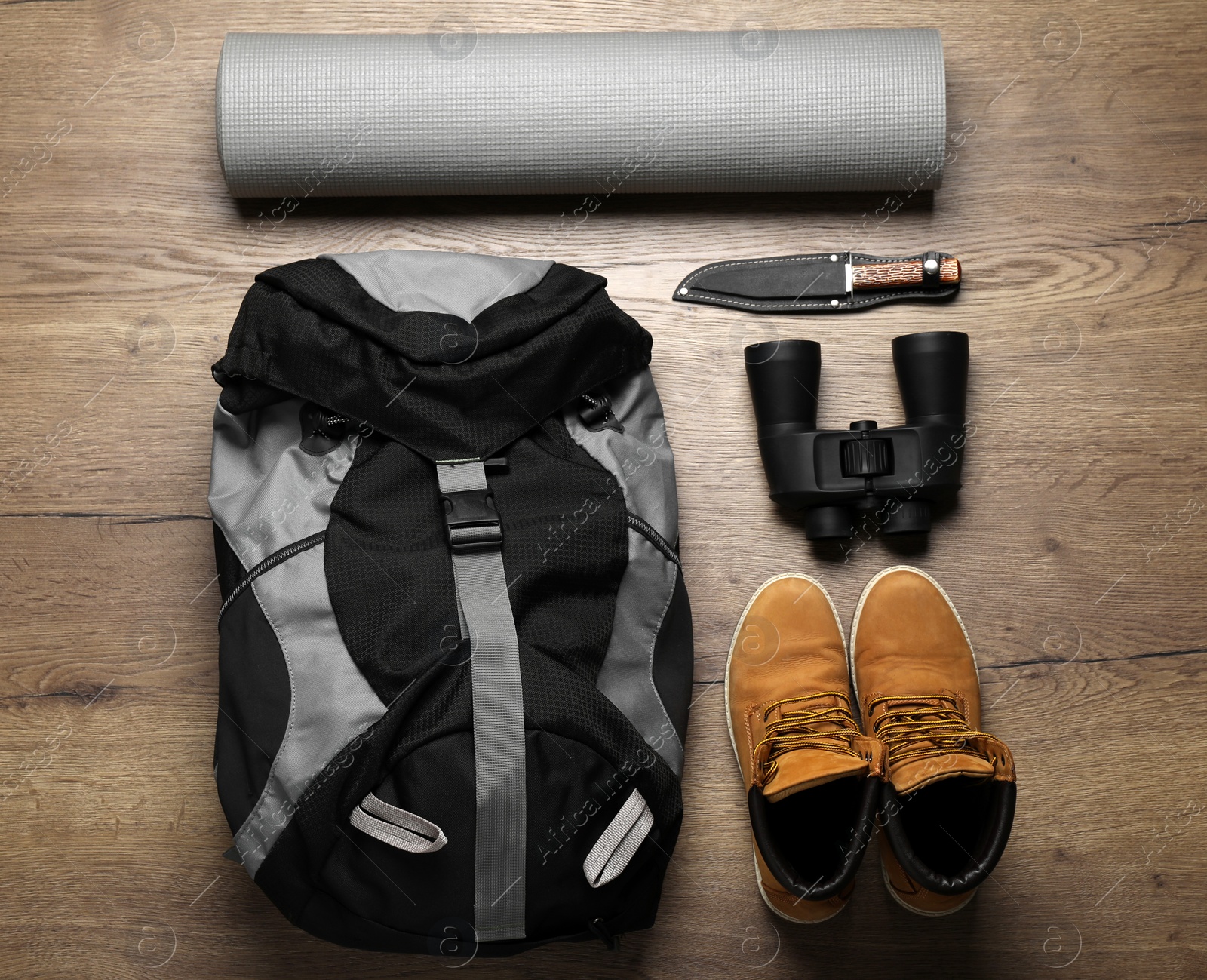 Flat lay composition with different camping equipment on wooden background Photo of Flat lay composition with different camping equipment on wooden background