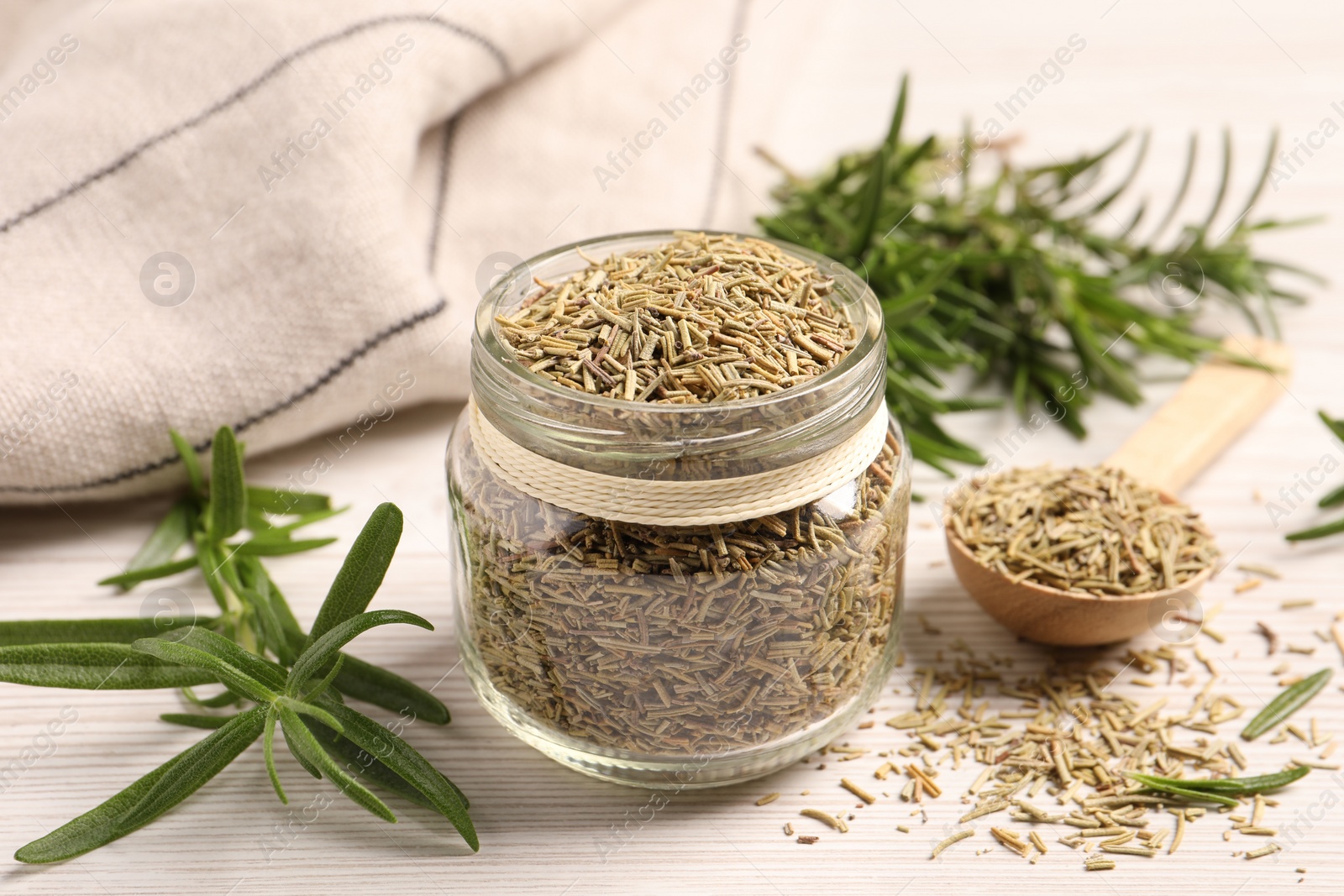 Photo of Fresh and dry rosemary on white wooden table