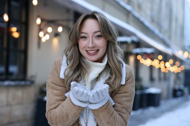 Portrait of smiling woman on city street in winter