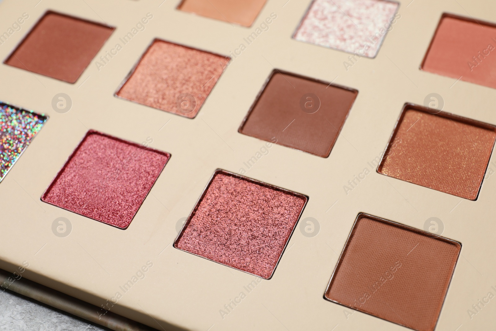 Photo of Beautiful eye shadow palette on grey table, closeup