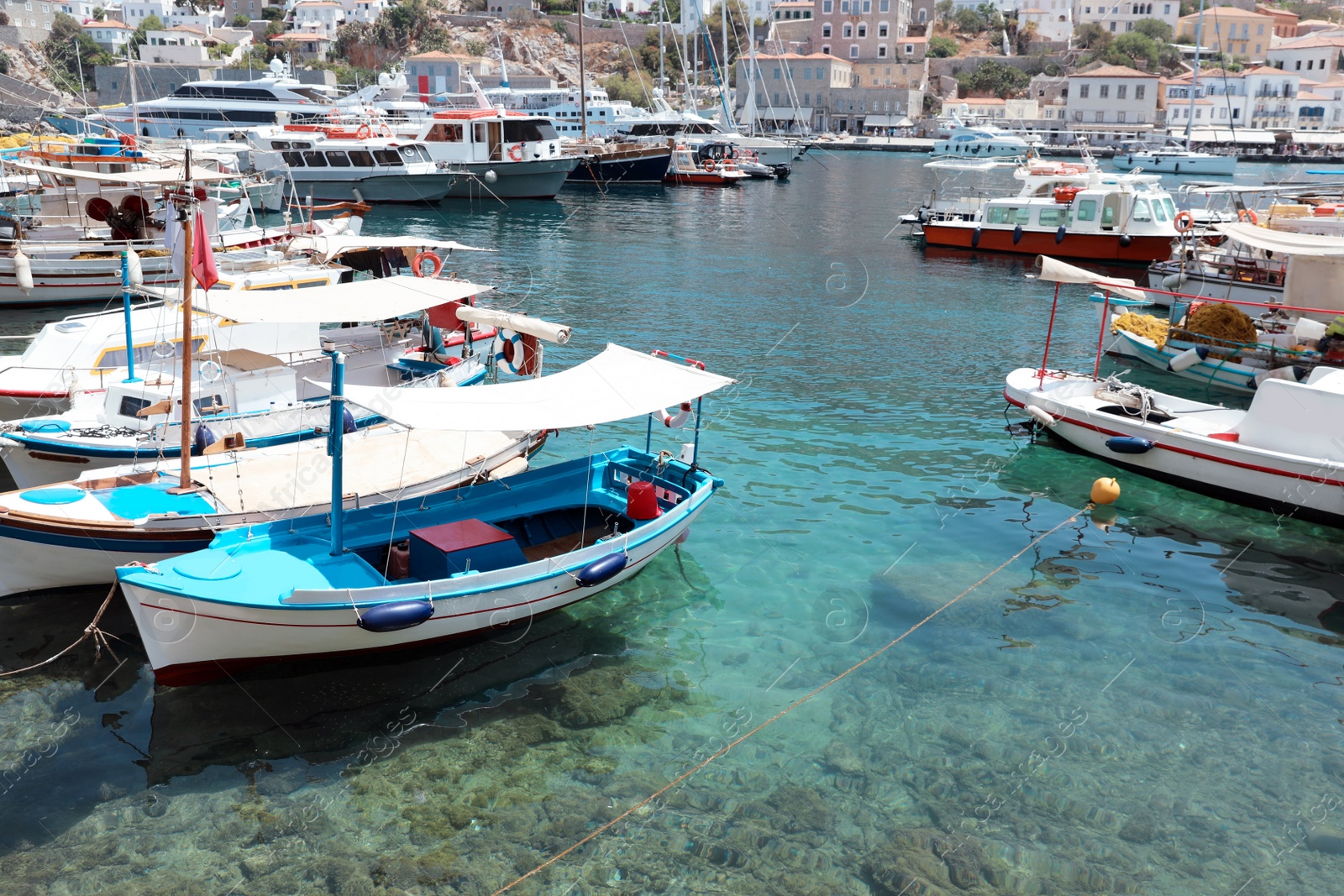 Photo of Beautiful view of coastal city with different boats on sunny day