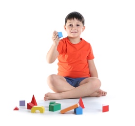 Photo of Cute child playing with colorful blocks on white background