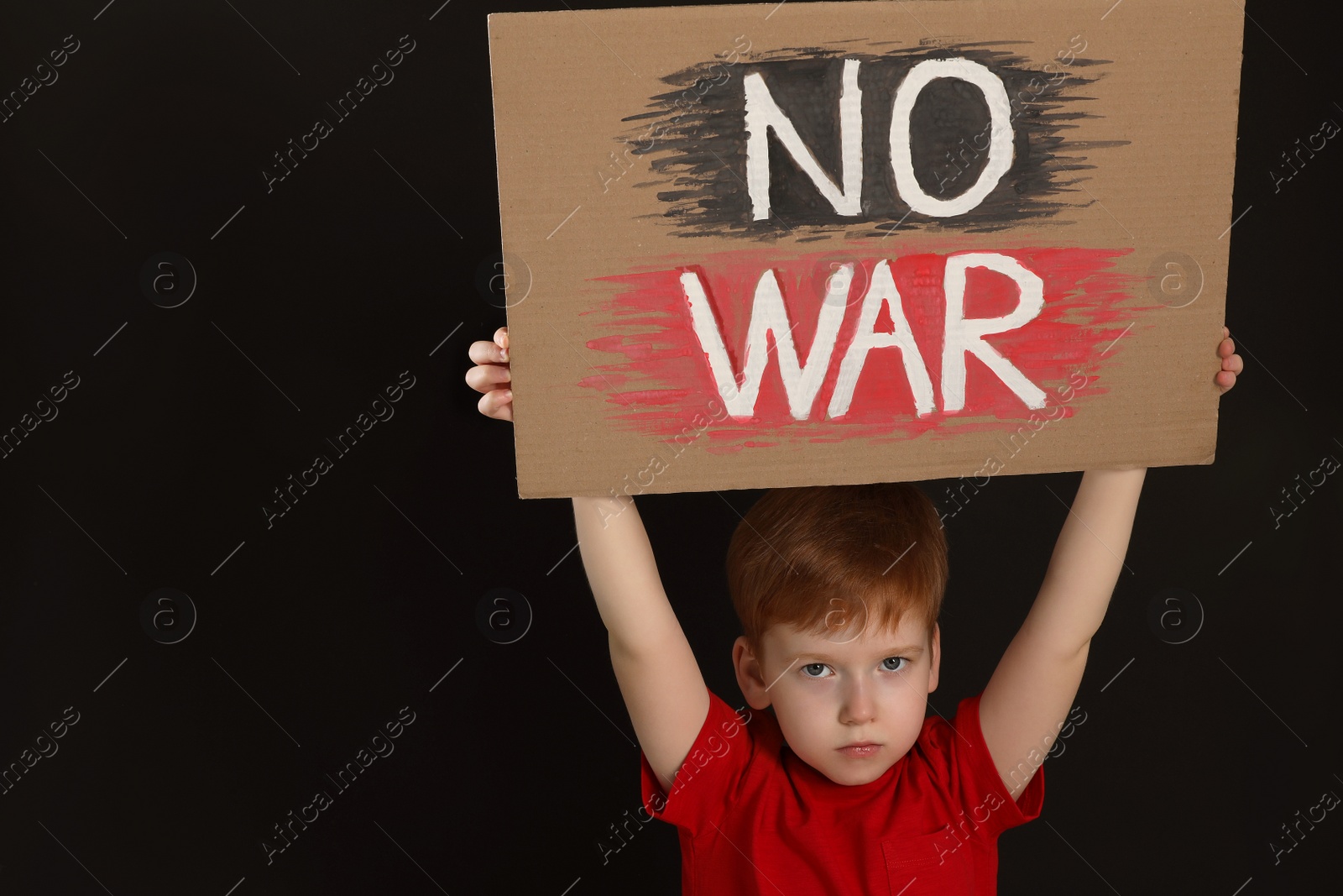 Photo of Boy holding poster No War against black background, space for text