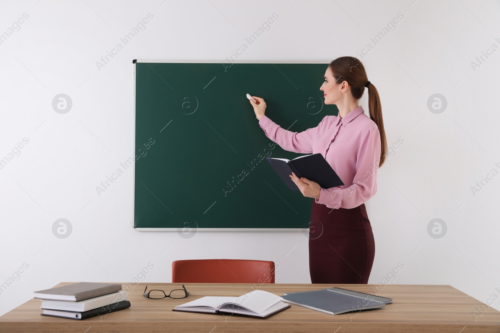 Photo of Portrait of young female teacher in classroom