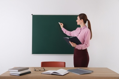 Photo of Portrait of young female teacher in classroom