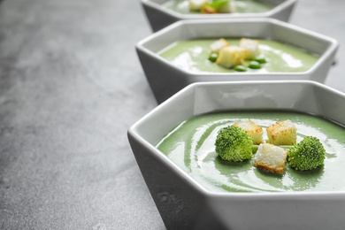 Fresh vegetable detox soup made of broccoli with croutons on table. Space for text