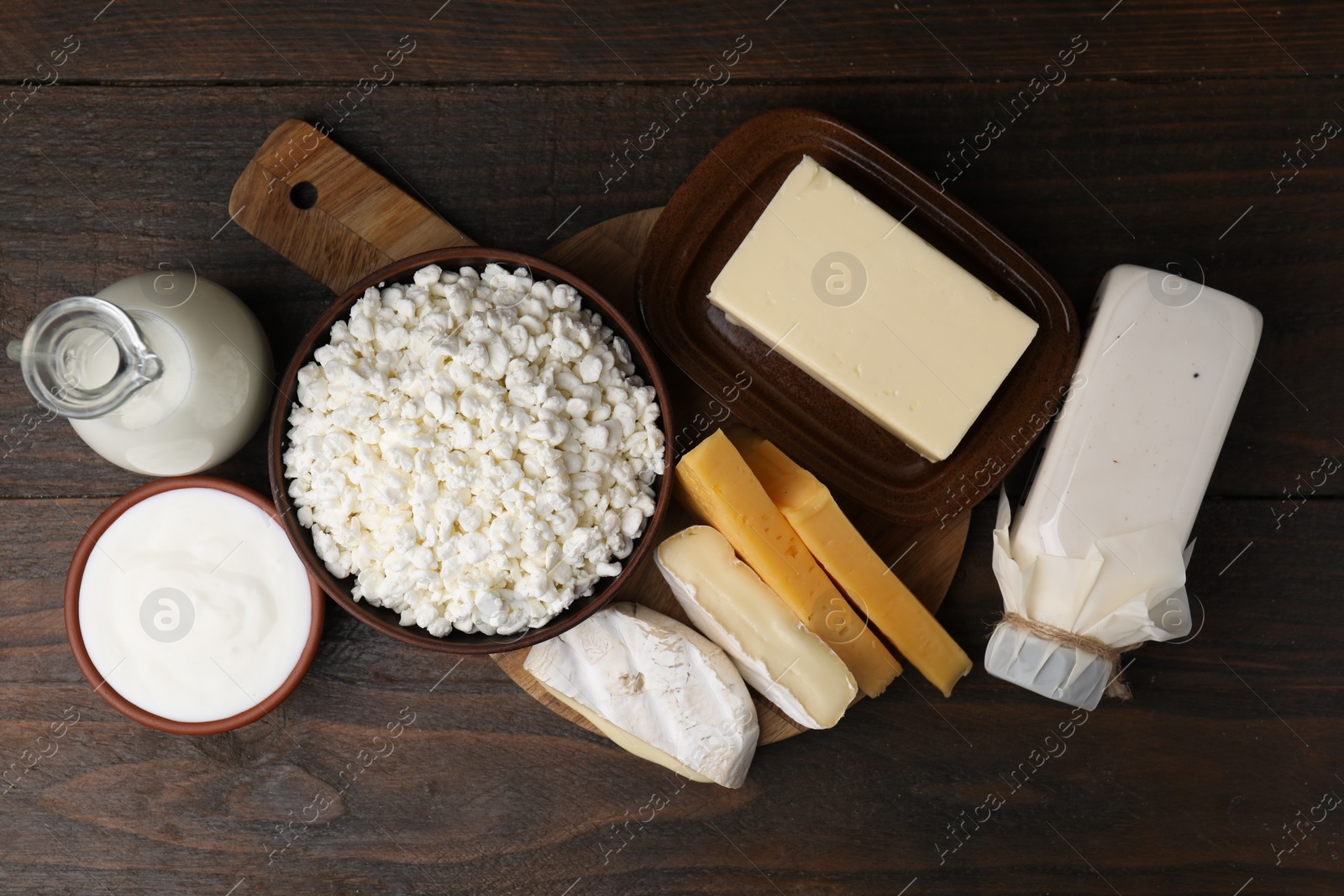 Photo of Different fresh dairy products on wooden table, flat lay