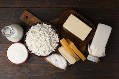 Different fresh dairy products on wooden table, flat lay